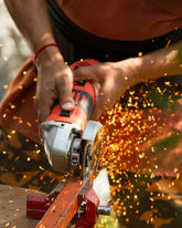 Person using a power tool with sparks flying, likely cutting metal.